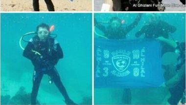 قصة صورة : غواص يرفع شعار الهلال تحت أعماق البحار